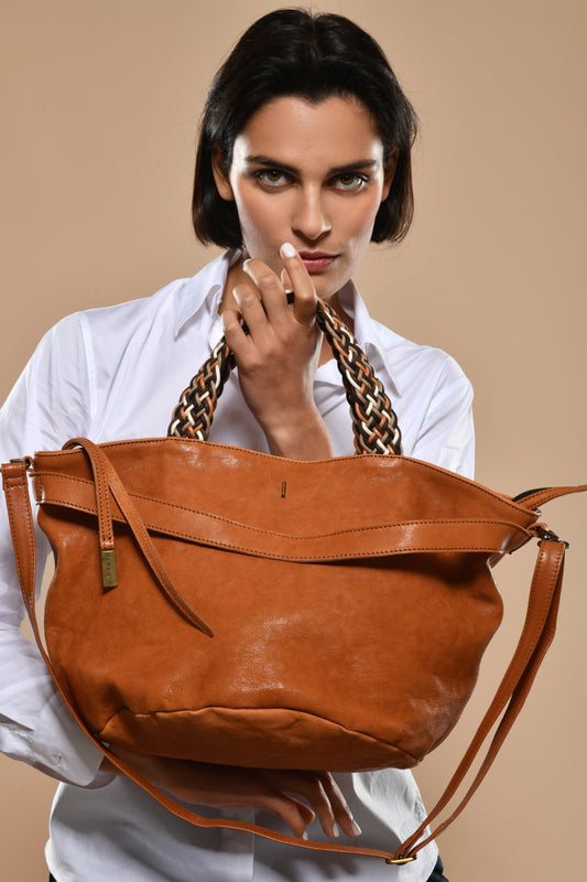 Biscuit Nappa leather handbag with braided handle on a white background
