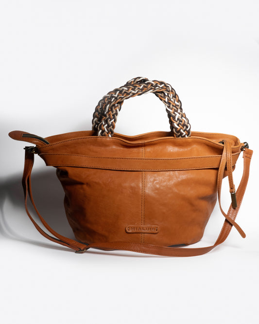 Biscuit Nappa leather handbag with braided handle on a white background