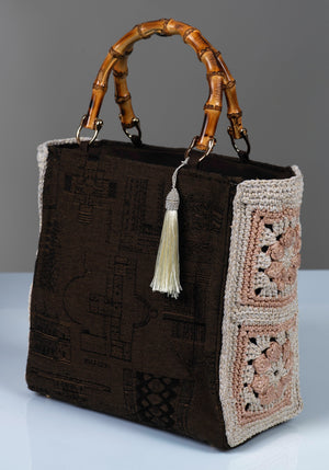 Chocolate brown monument-motif cotton handbag with bamboo handles and crochet side panels.